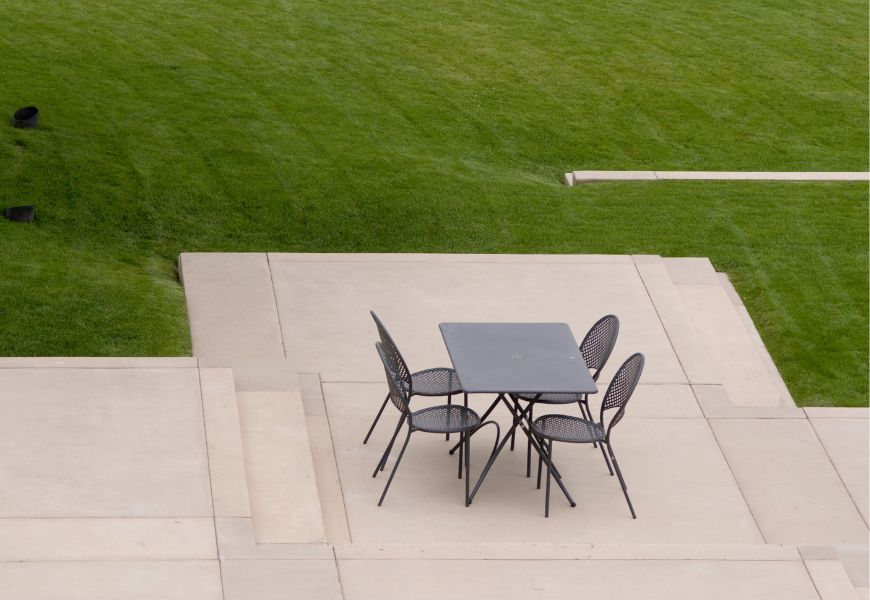 clean cement patio with table and chairs